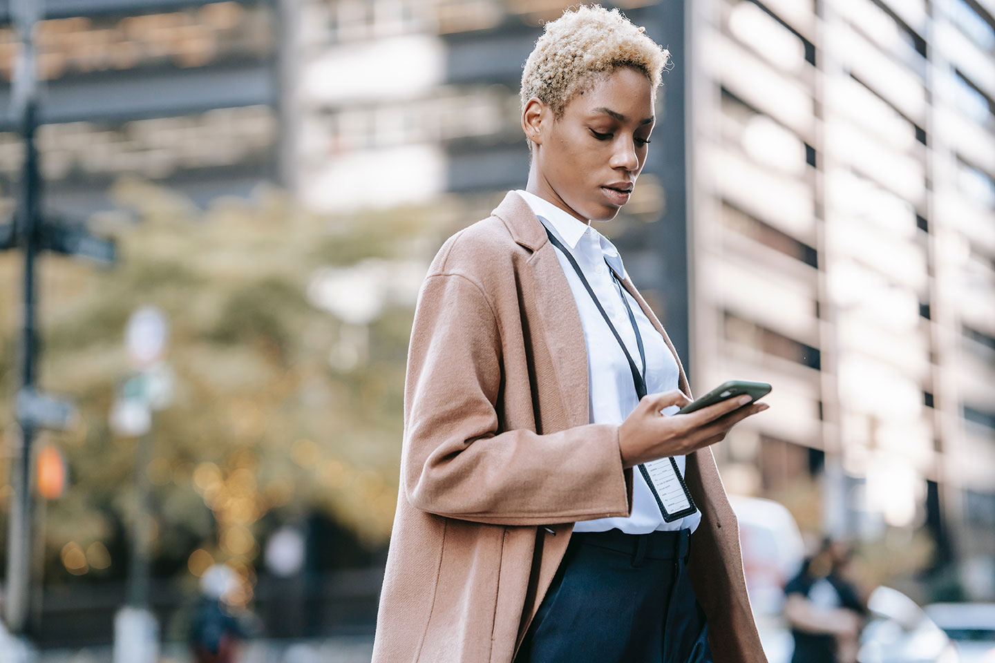 afro american business woman standing in the city with the smartphone