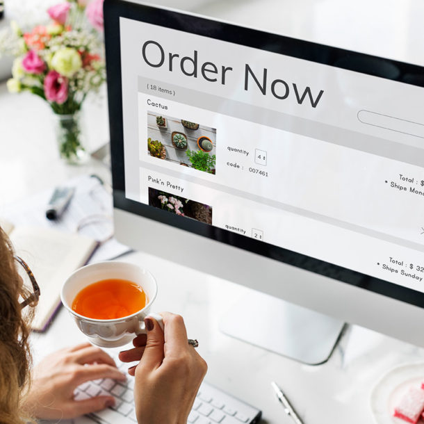 woman making online shopping using imac and drinking tea